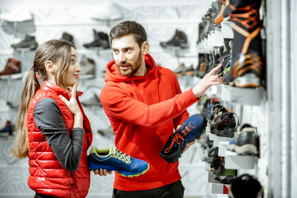 Man and woman choosing shoes in the shop